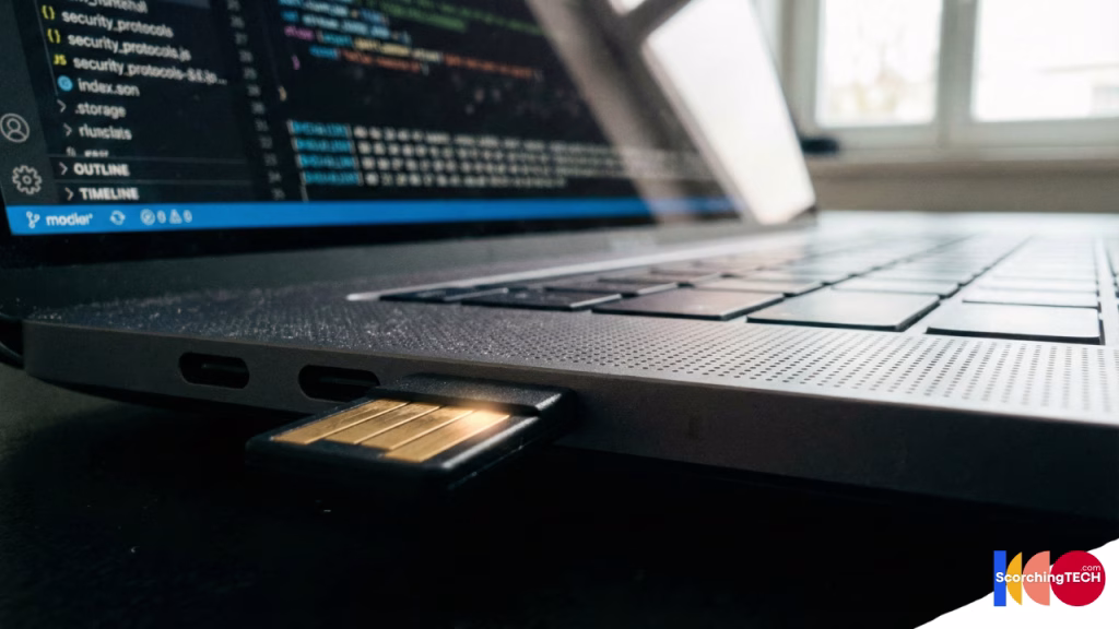 Macro photography of a YubiKey 5C plugged into a laptop USB-C port ready for authentication.